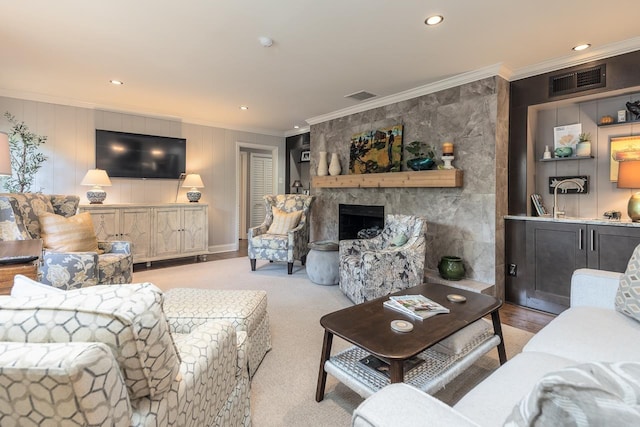 carpeted living room with a fireplace and ornamental molding