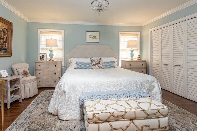 bedroom with multiple windows, crown molding, and a closet