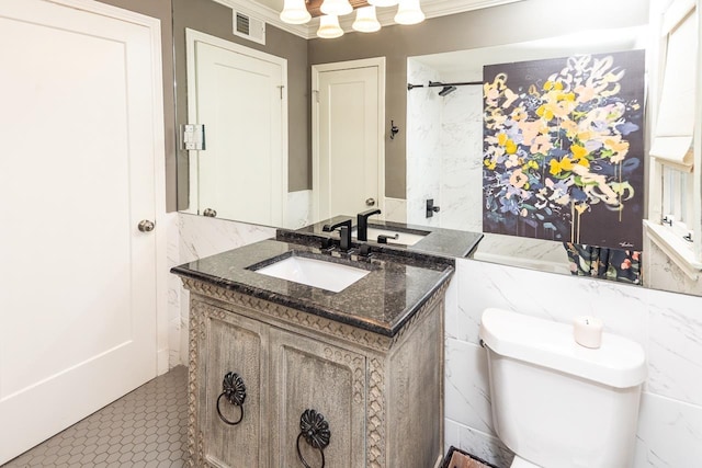 bathroom with vanity, toilet, and ornamental molding