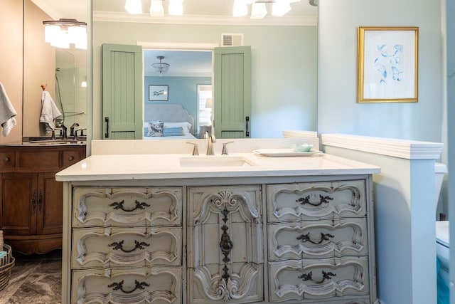 bathroom featuring crown molding and vanity