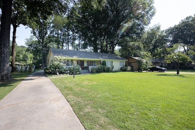 ranch-style home with a front lawn