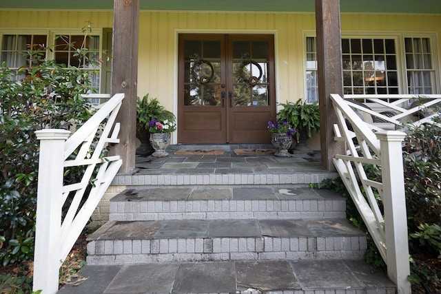 doorway to property with covered porch and french doors