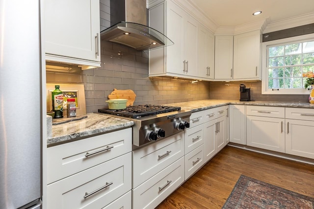 kitchen featuring white cabinetry, wall chimney exhaust hood, stainless steel gas cooktop, light stone counters, and dark hardwood / wood-style floors