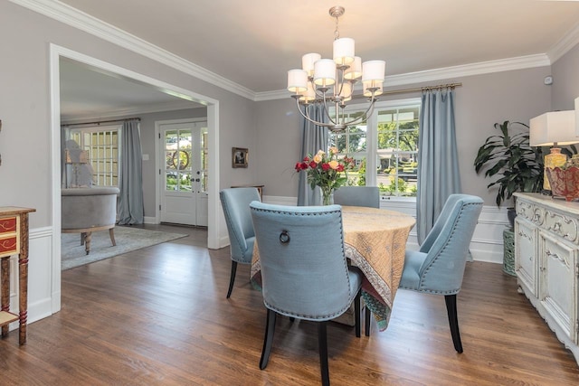 dining room featuring a notable chandelier, crown molding, and dark wood-type flooring