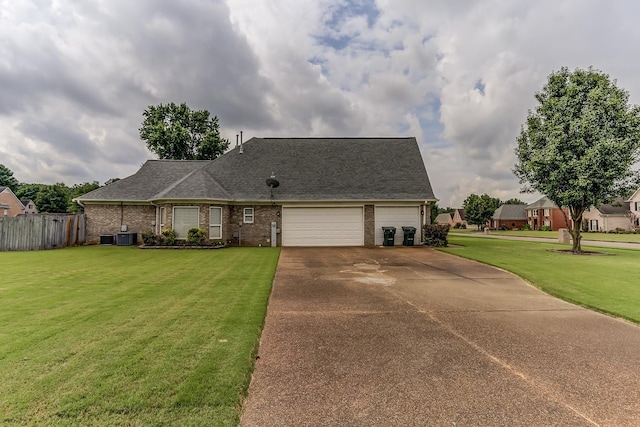 ranch-style house featuring a garage, central air condition unit, and a front yard