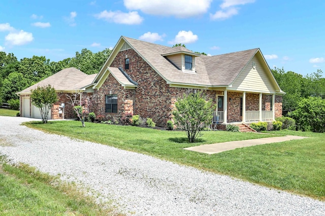 view of front facade with a garage, a porch, and a front yard