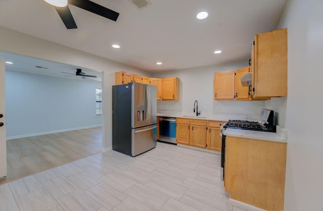 kitchen featuring ceiling fan, light brown cabinetry, appliances with stainless steel finishes, and sink