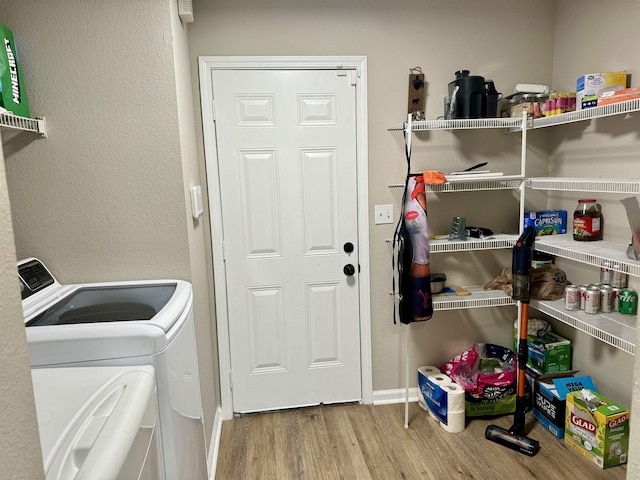 laundry room with light hardwood / wood-style floors and separate washer and dryer