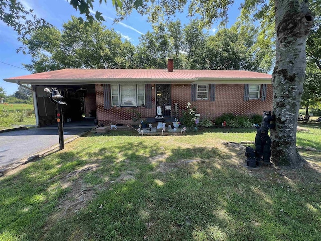 single story home featuring a front lawn and a carport