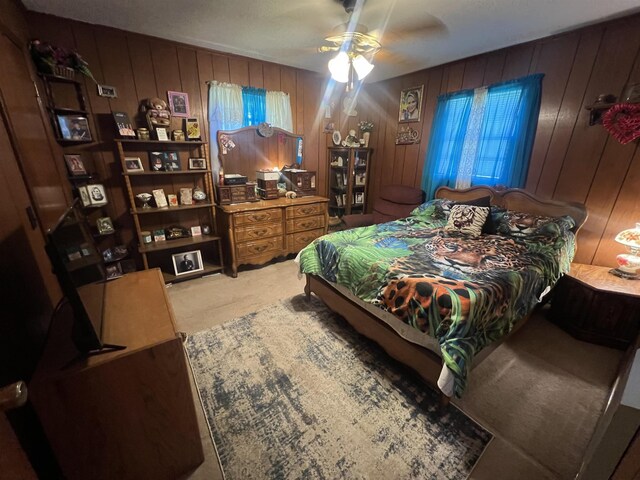 carpeted bedroom with wooden walls and ceiling fan