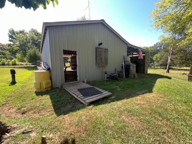 view of outbuilding with a lawn