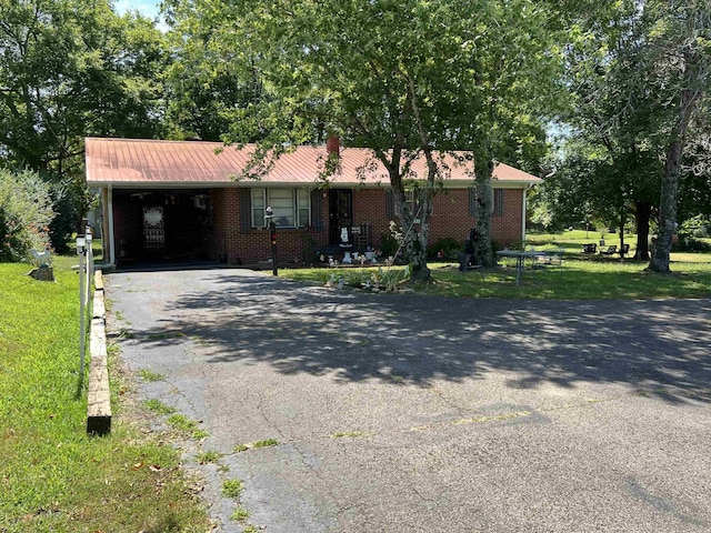 single story home featuring a front yard and a carport