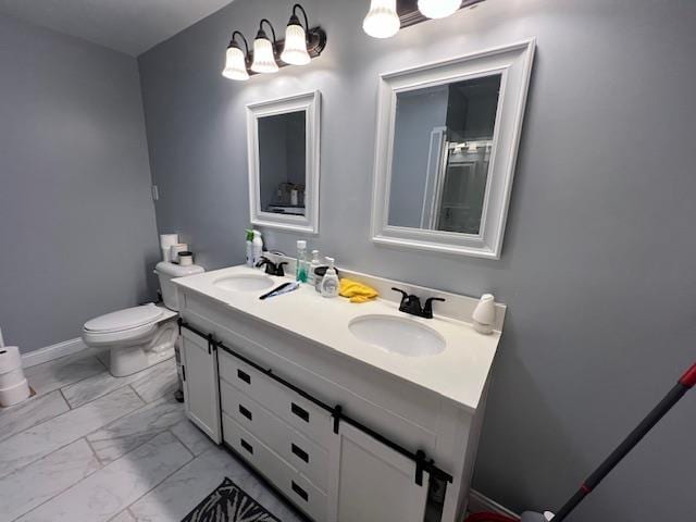 bathroom featuring vanity and toilet