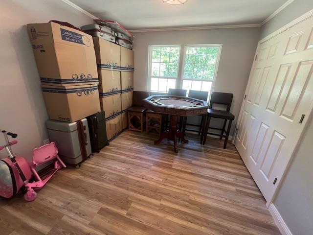 dining space with hardwood / wood-style floors and ornamental molding