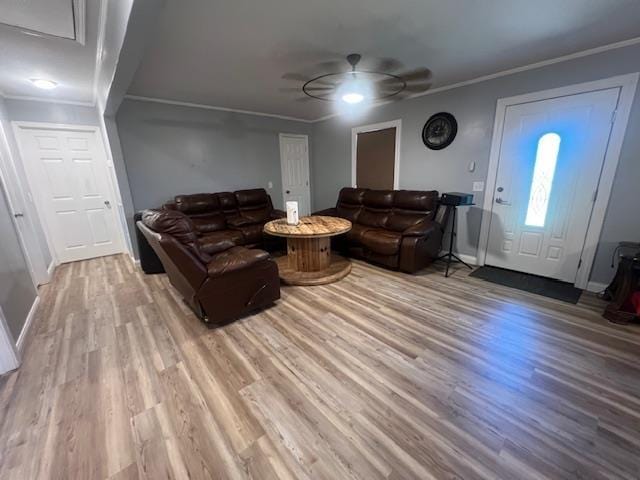 living room with crown molding, hardwood / wood-style floors, and ceiling fan