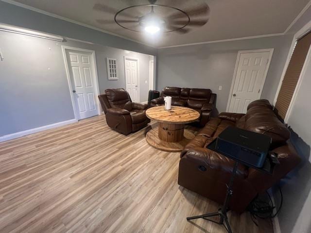 living room with light hardwood / wood-style floors and crown molding