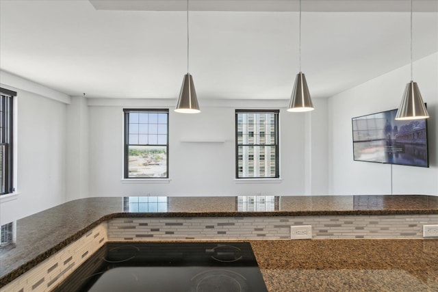 kitchen with decorative light fixtures and plenty of natural light