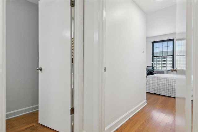 hallway with hardwood / wood-style floors