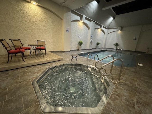 view of swimming pool with an indoor hot tub