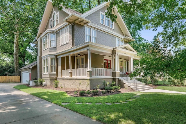 view of front of home featuring a garage, a front yard, ceiling fan, and a porch