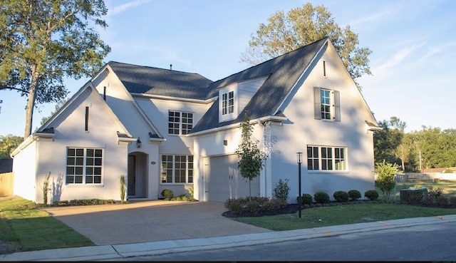 view of front of property featuring a garage and a front lawn