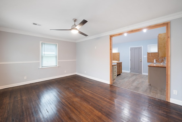 empty room featuring crown molding, ceiling fan, and dark hardwood / wood-style flooring