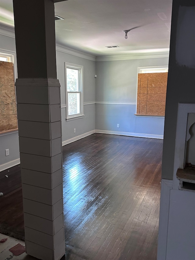 unfurnished living room with dark wood-type flooring and ornamental molding