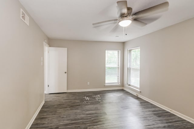 unfurnished room featuring dark hardwood / wood-style floors and ceiling fan