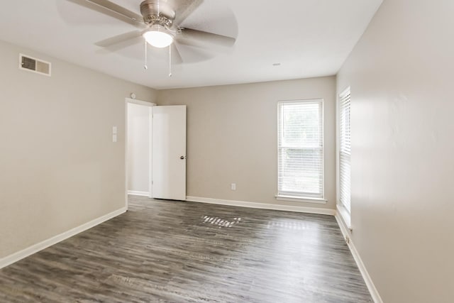 empty room featuring dark hardwood / wood-style floors and ceiling fan