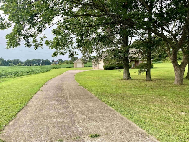 surrounding community featuring a lawn and an outdoor structure