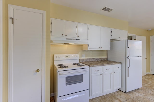 kitchen featuring light tile patterned flooring, white cabinetry, and white appliances