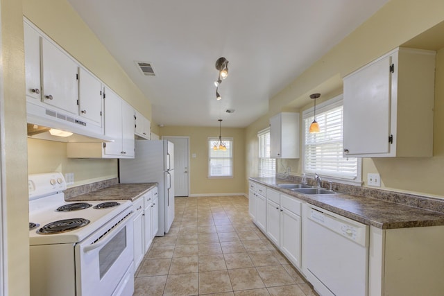 kitchen with white cabinetry, sink, white appliances, and pendant lighting