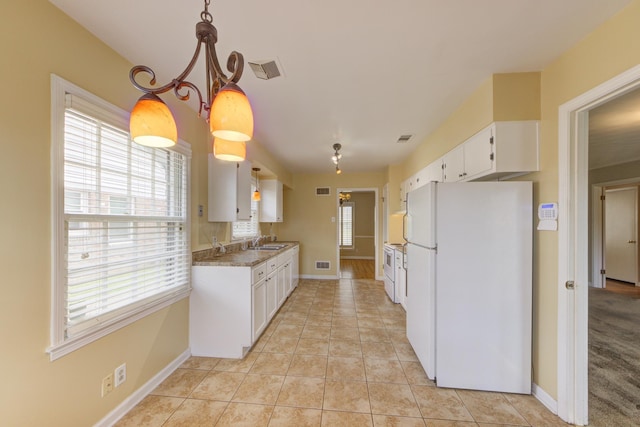 kitchen featuring white cabinetry, white appliances, pendant lighting, light stone counters, and sink