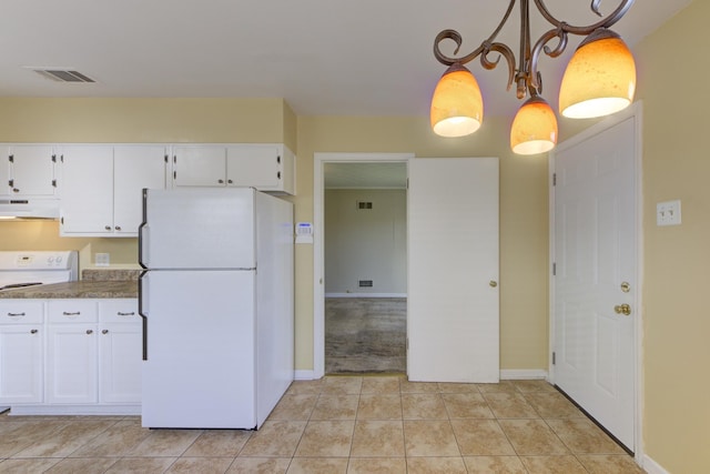 kitchen with light tile patterned flooring, decorative light fixtures, white cabinets, and white appliances