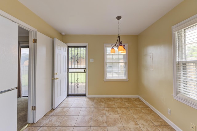 interior space with light tile patterned floors and a notable chandelier