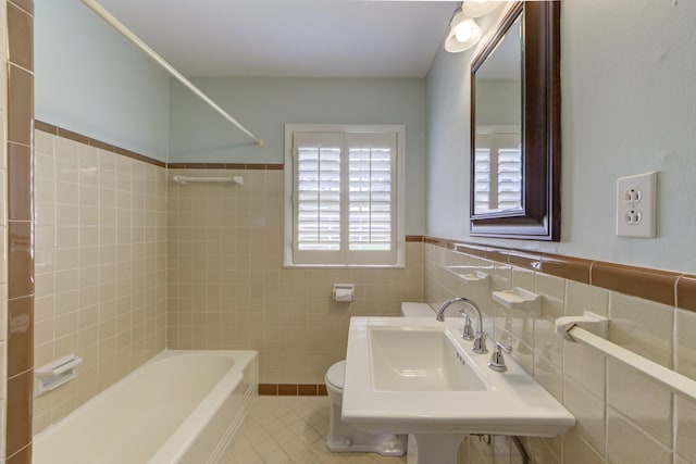 full bathroom with toilet, shower / washtub combination, tile patterned flooring, tile walls, and sink