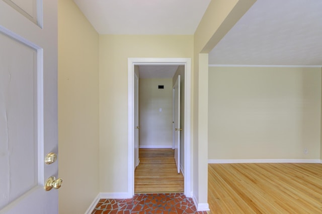 corridor with dark hardwood / wood-style flooring