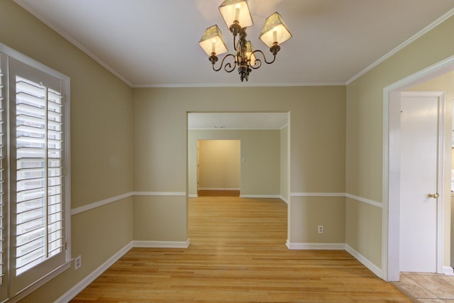 unfurnished dining area with ornamental molding, a chandelier, and light hardwood / wood-style flooring