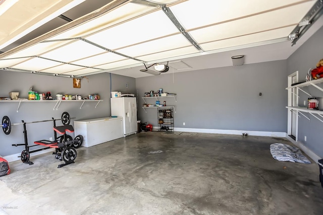 garage featuring white fridge with ice dispenser