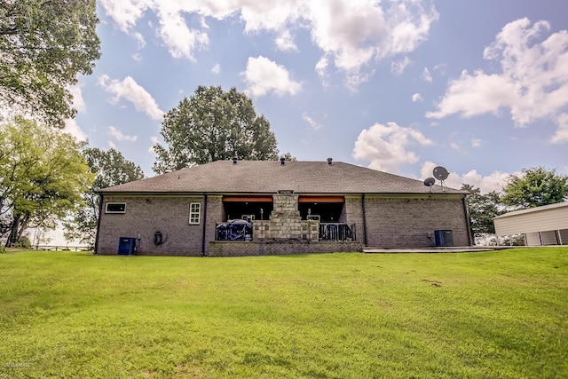 back of house with cooling unit and a yard