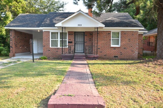 view of front facade with a carport and a front yard