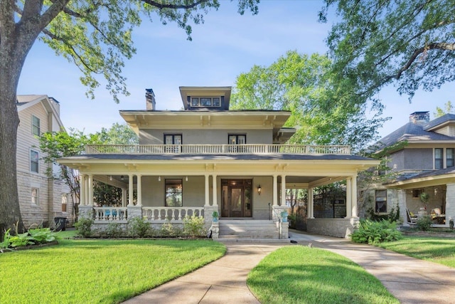 view of front of house with a porch and a front yard