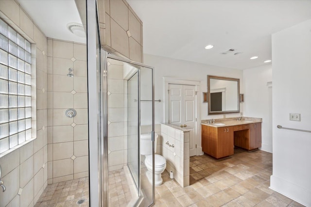 bathroom with vanity, toilet, and walk in shower