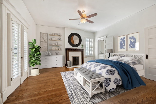 bedroom with access to exterior, ceiling fan, and dark hardwood / wood-style floors