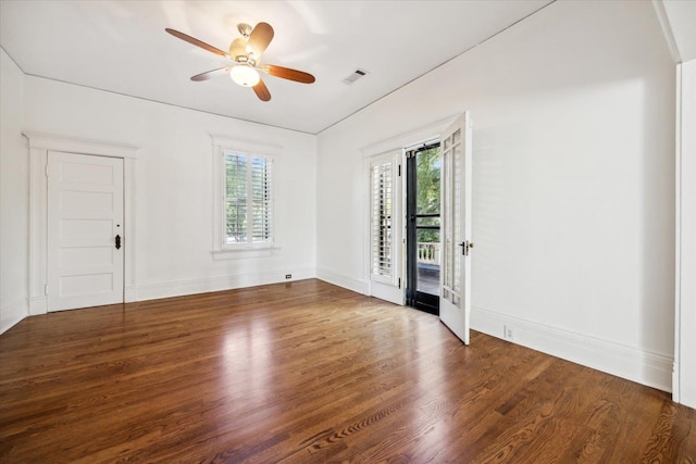 spare room with ceiling fan and dark wood-type flooring