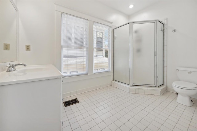 bathroom with tile patterned flooring, vanity, toilet, and a shower with door