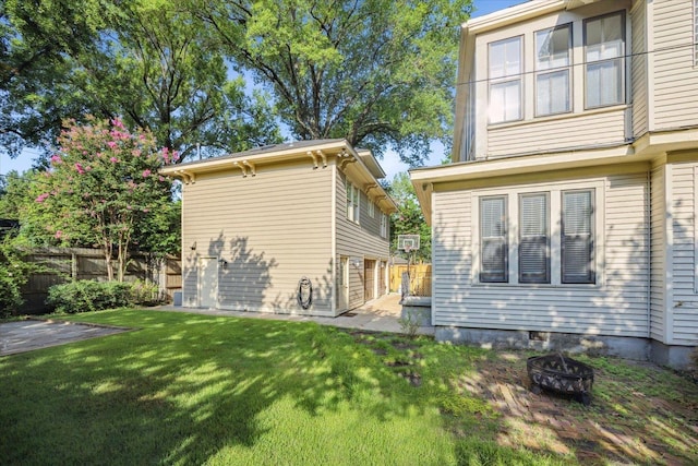 view of property exterior with a yard and a fire pit