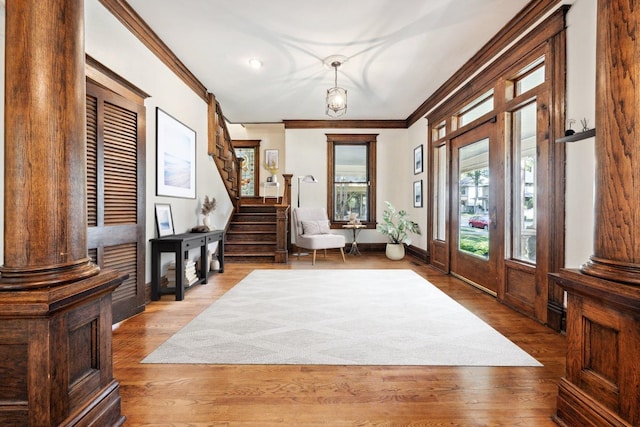 foyer entrance featuring hardwood / wood-style floors and ornamental molding