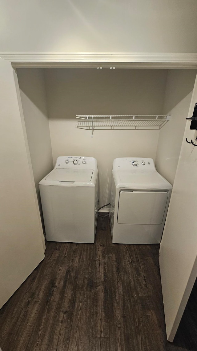 laundry area with dark wood-type flooring and independent washer and dryer