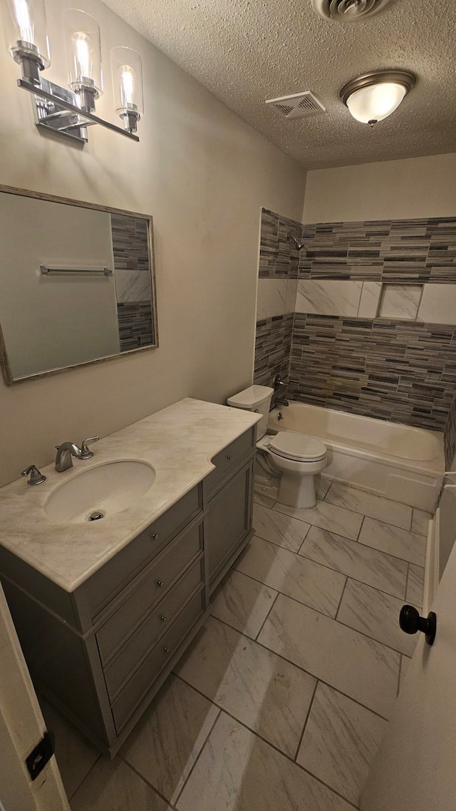 full bathroom featuring vanity, tub / shower combination, and a textured ceiling